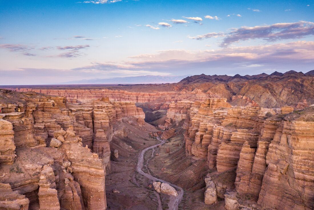 High view of Charyn Canyon's striated pointing sides with a path going down the center in northern Khazakhstan