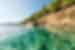 Intrepid traveller dives off submerged rock into the Aegean Sea off the coast of Alonnisos in the Sporades archipelago in Greece