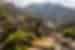Rijal Almaa village with green vegetation growing on it and mountains in the background, Saudi Arabia