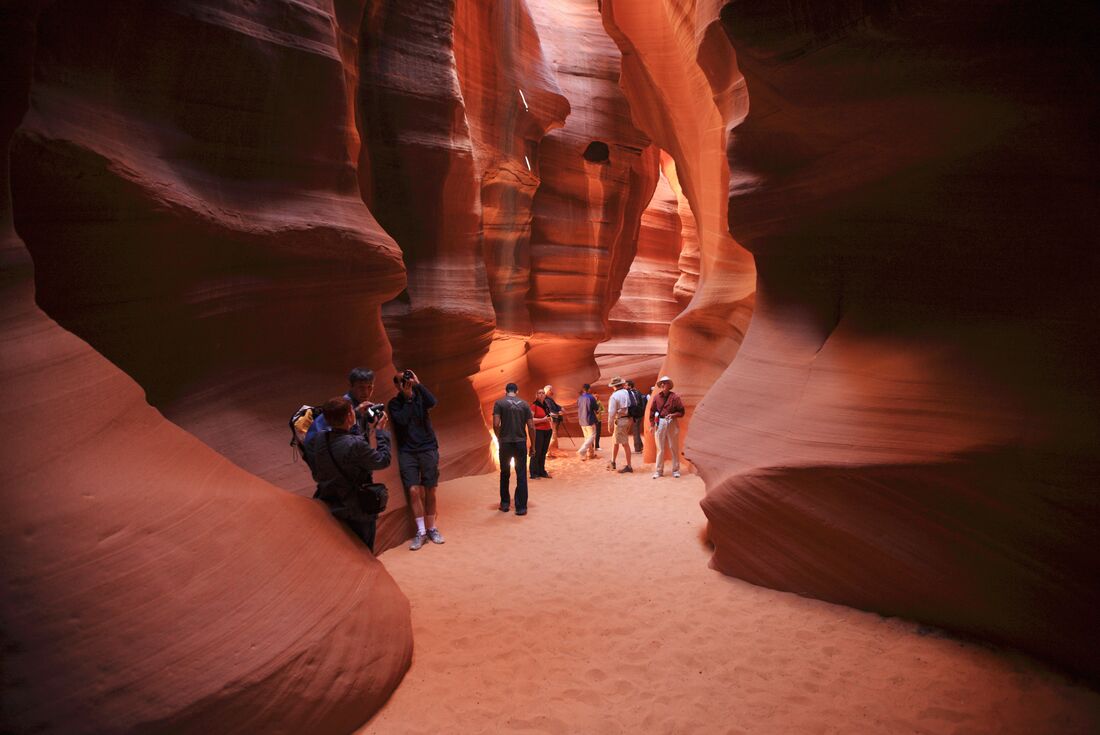 Travellers walking through rock formations in Antelope Canyon, Arizona, USA