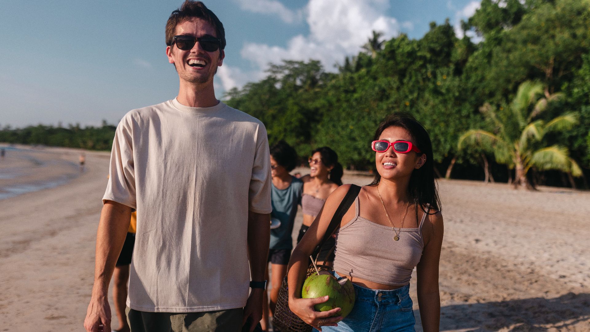 Young travellers laughing on the beach