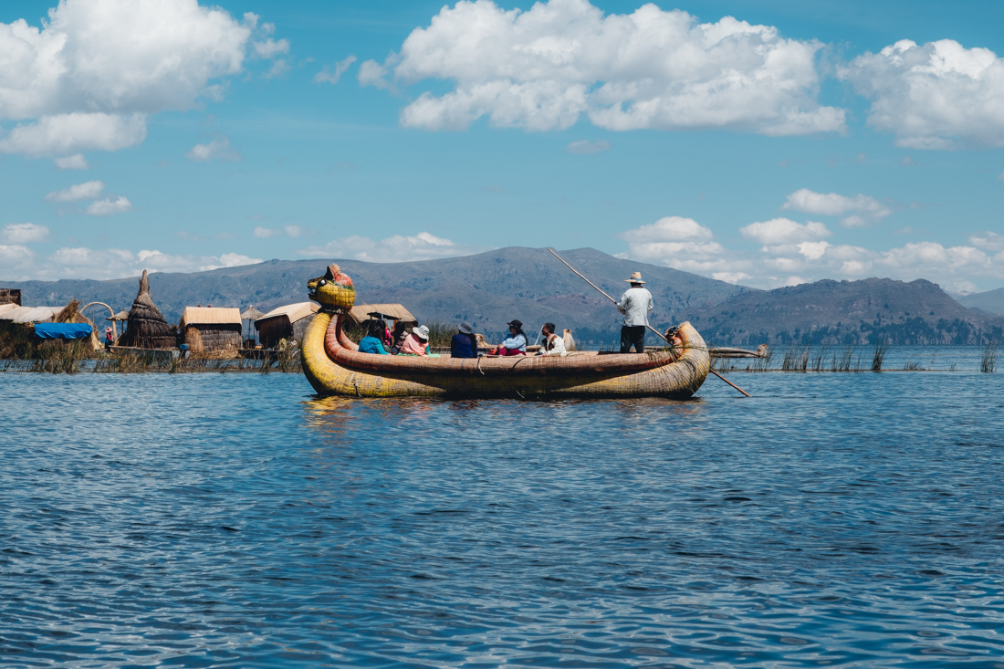 Intrepid travellers cross a reed boat to the Floating Island of Lake Titicaca