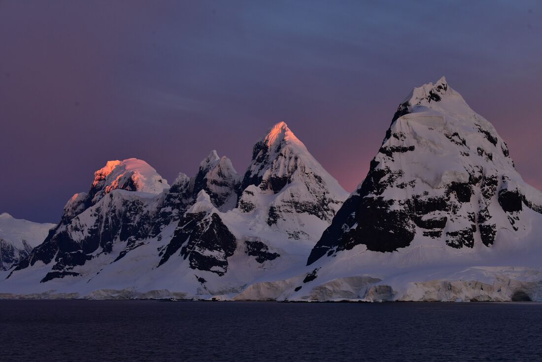 Sunrise on the towering mountains of the Bismark Strait
