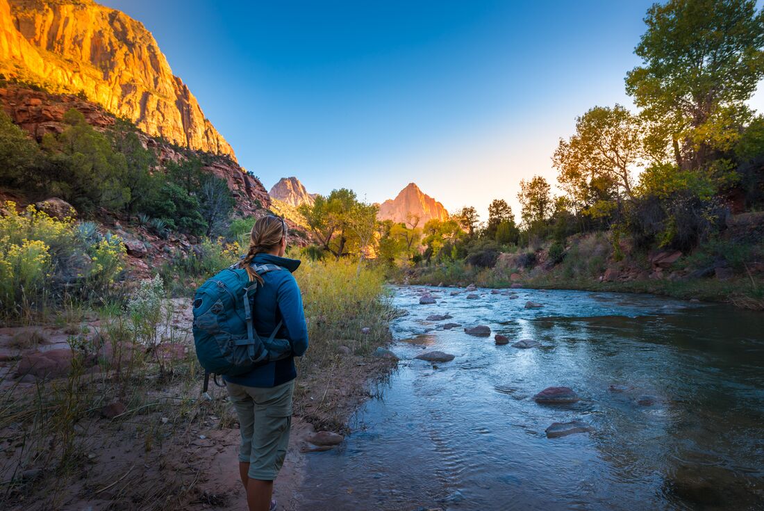 Traveller stops on the Watchman Trail to look at the landscape in Zion National Park in Utah