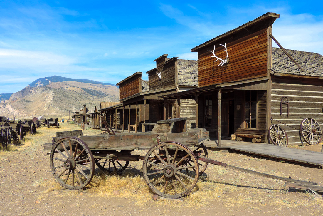 Wild west ghost town of Cody, Wyoming with abandoned wagons and shopfronts