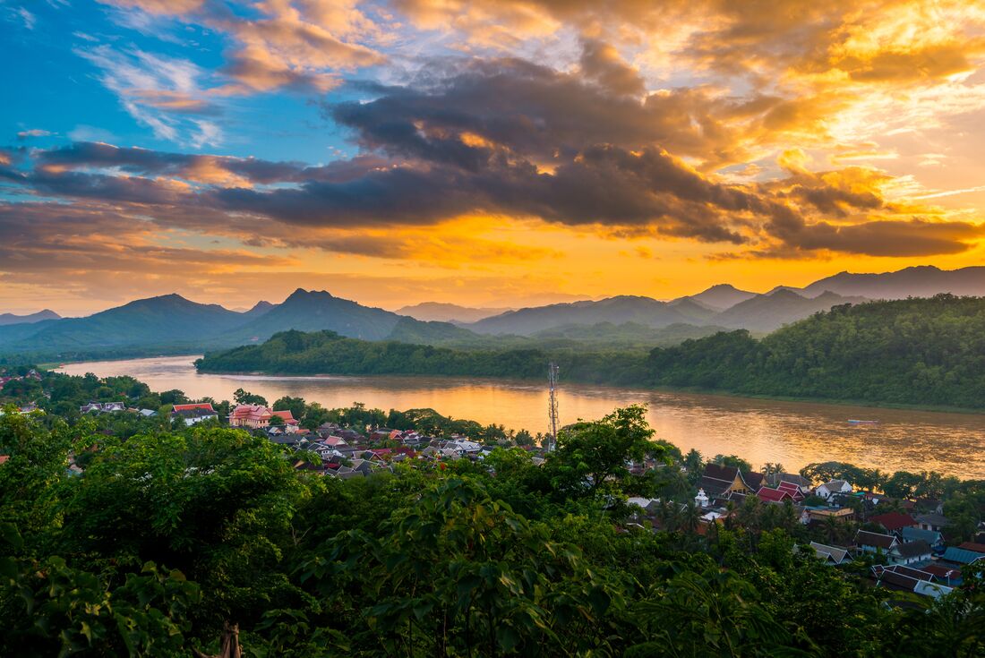 Luang Prabang sunset over Mount Phousi and the Mekong River winding through the Laos countryside