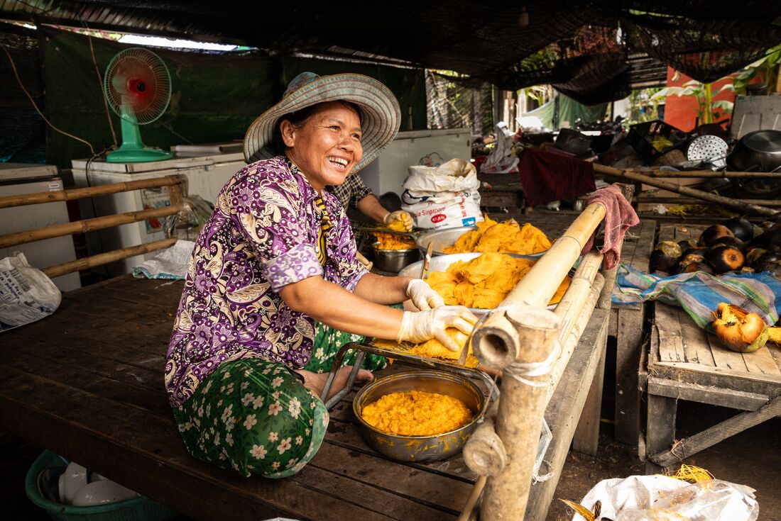 Local lady smiling as she is preparing fruit, Cambodia