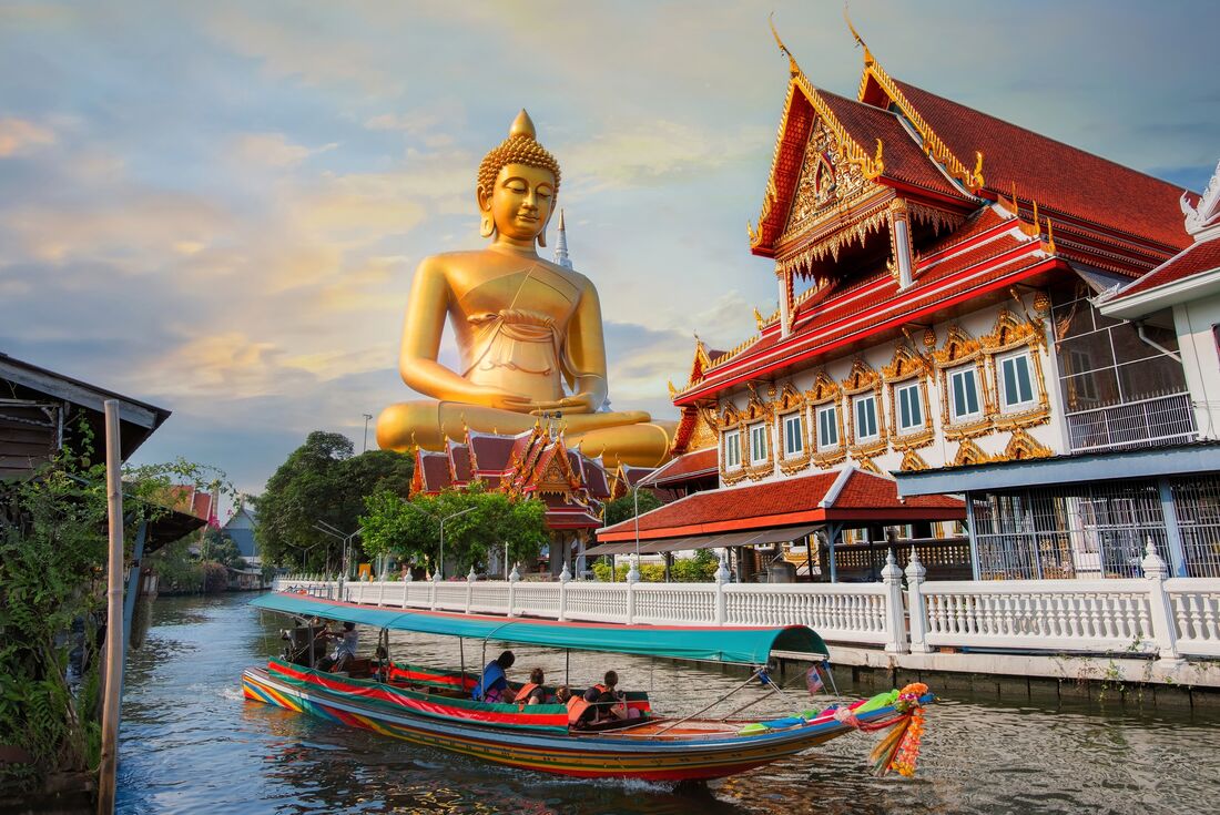 Giant seated buddha at Wat Paknam Phasi Charoen by canal, Bangkok