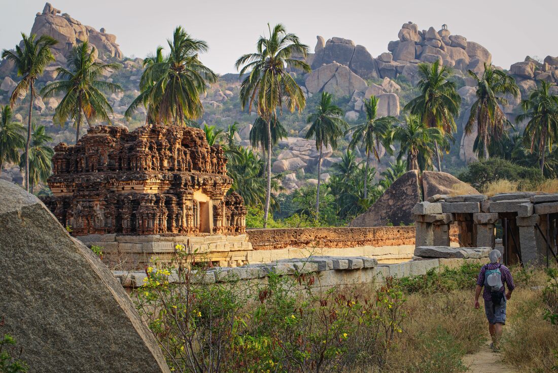 Exploring the grounds of Vittala Temple among the ancient temples and monuments of Hampi