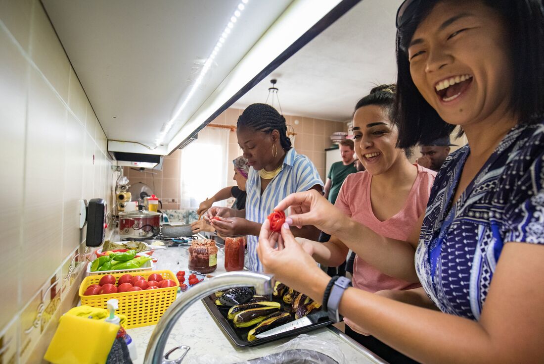 Intrepid travellers take a cooking class in Cappadocia laughing and smiling as they do