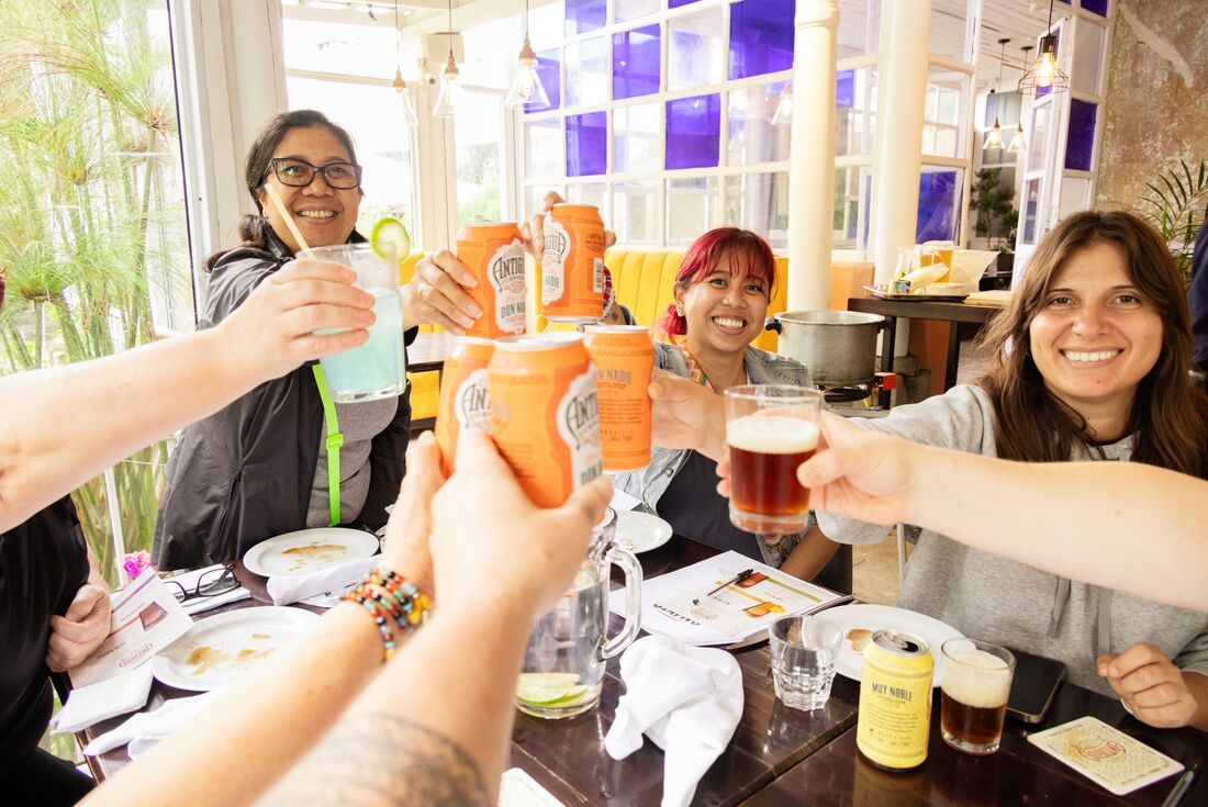 Intrepid group and local guide join a happy cheers in Quetzaltenango Guatemala