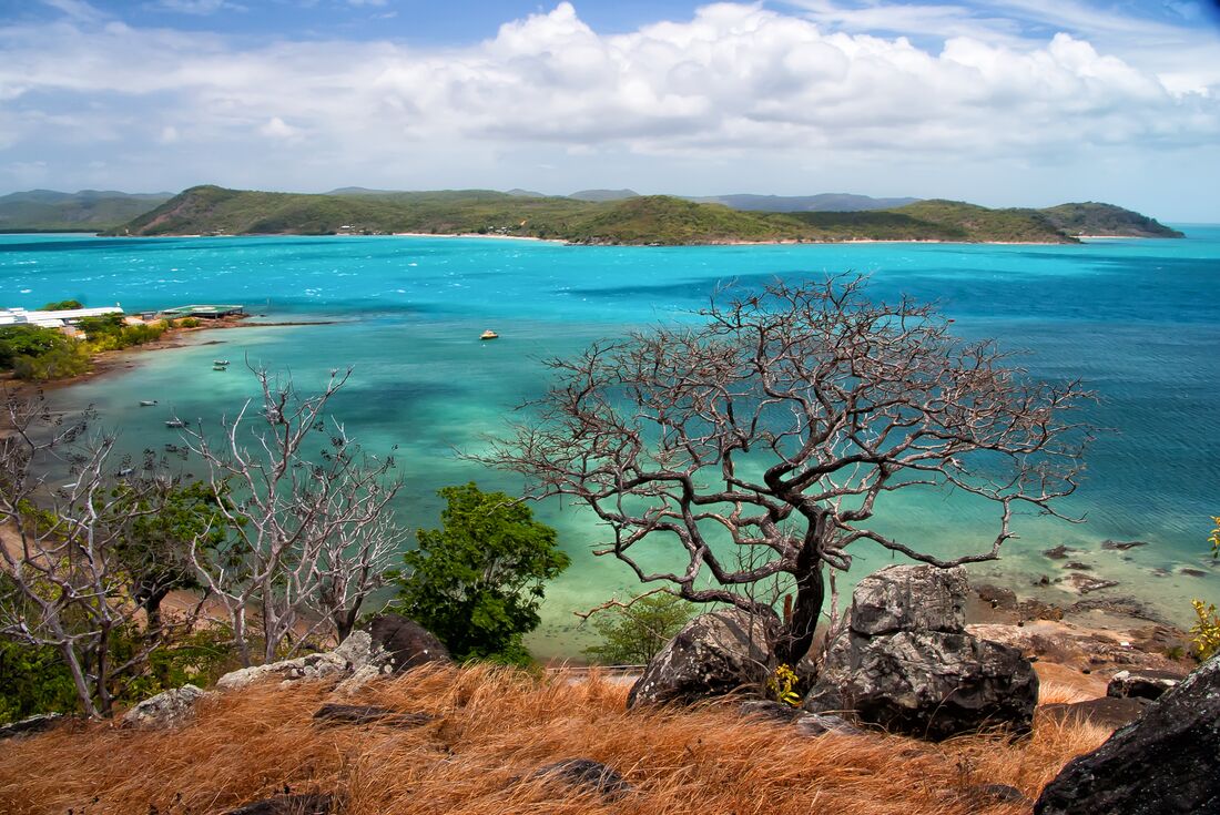 Blue and green ocean water stretches out away from the edge of Thursday Island in the Torres Strait off of northern Queensland