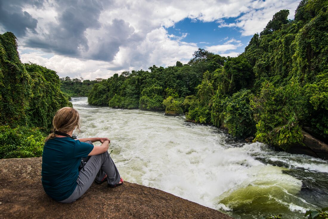 Intrepid traveller in repose looks out over the source of the Nile River in Jinja, Uganda