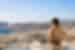 Traveller enjoying the view over the town and mountainous landscapes in Syros, Greece