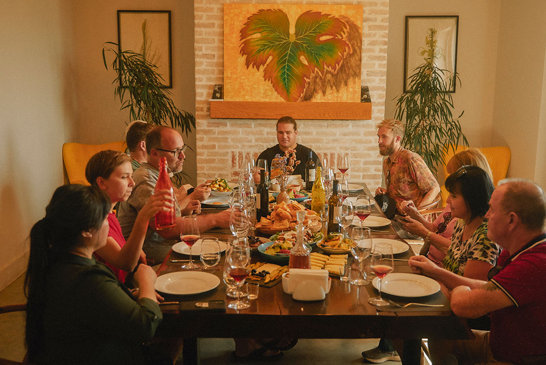 Intrepid travellers and leader enjoy a wine tasting dinner in Khaketi at a winery hotel