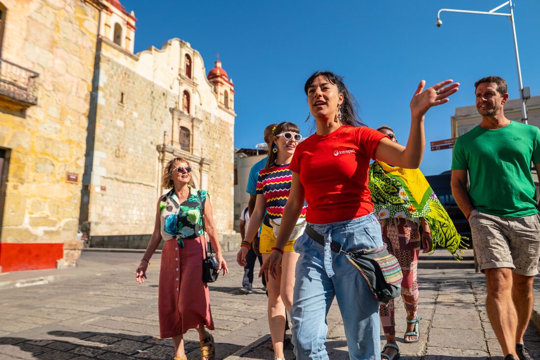 Intrepid leader guides group of happy travellers through the streets of Oaxaca 