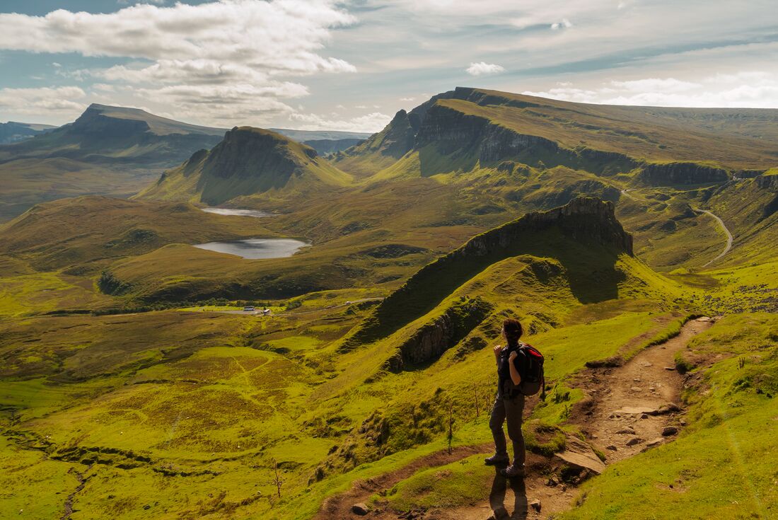 Intrepid traveller looking out at the landscape while walking Quiraing loop on the Isle of Skye 