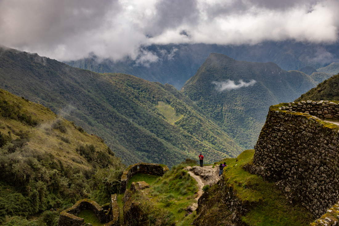 Intrepid travellers look over Phuyupatamarca Archaeological Site 