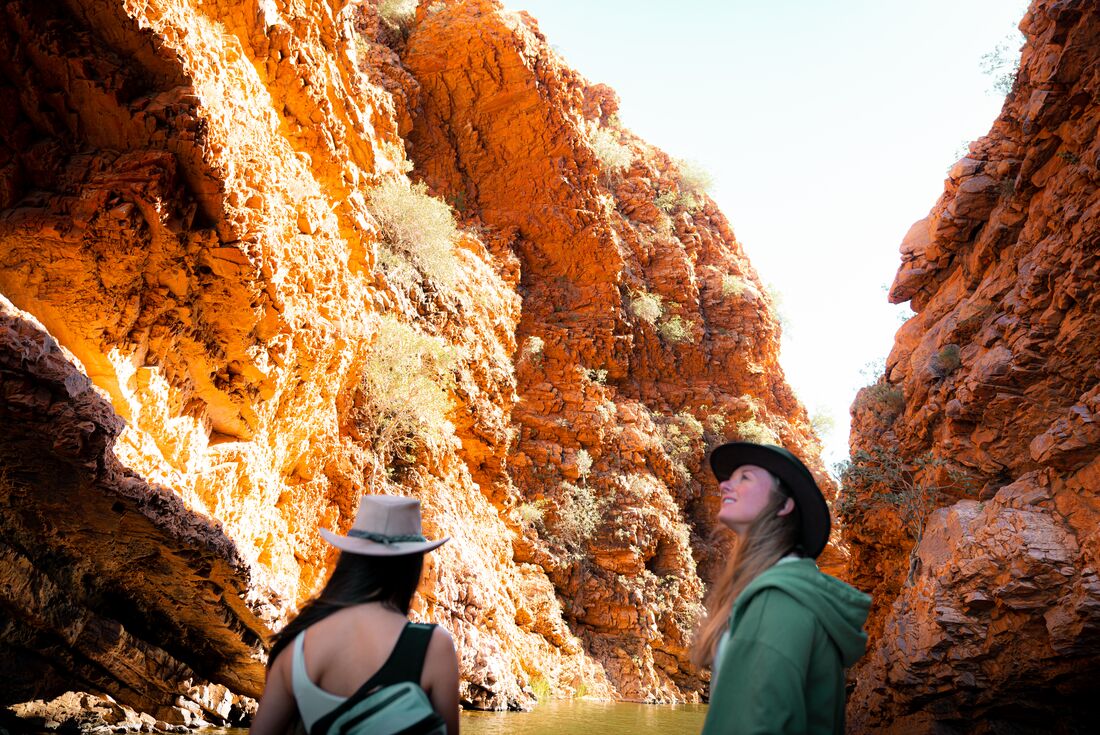 Intrepid traveller Cliona looking up and marvelling at the beauty of Simpsons Gap in the Northern Territory Australia