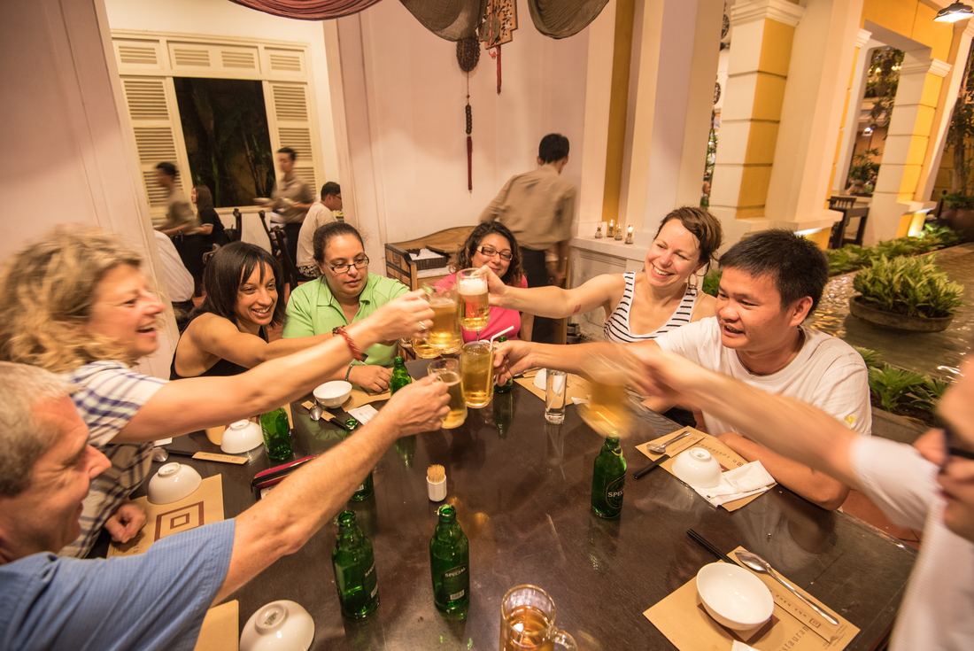 vietnam mekong ho chi minh city traveller group beer toast leader