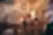 Three young people toast their glasses as they sit in a heavily-graffitied dive bar