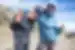 Hiker smiles with leader on the way to Mount Kilimanjaro