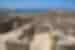 Walking throught the stone walled footprints of Greek ruins of Delos island in the Cyclades