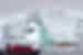 Everyone stops to take in the fragile scale of an arched iceberg off the Antarctic coast