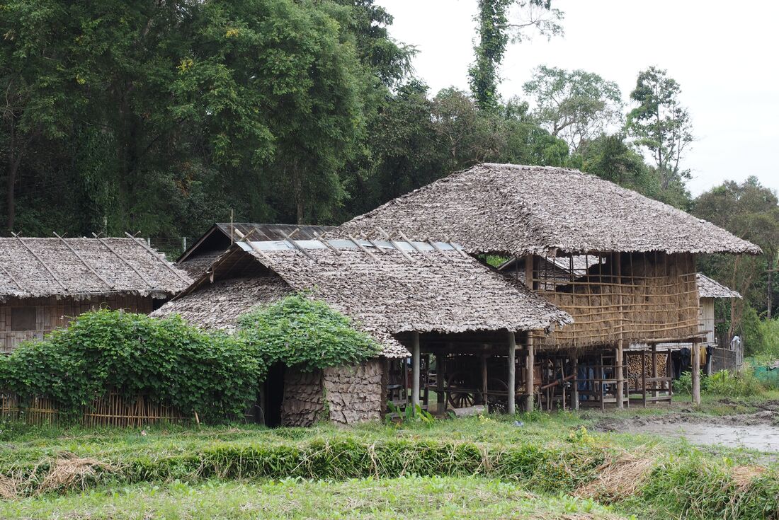 Thatched roof housing in a Hmong Village in Northern Thailand