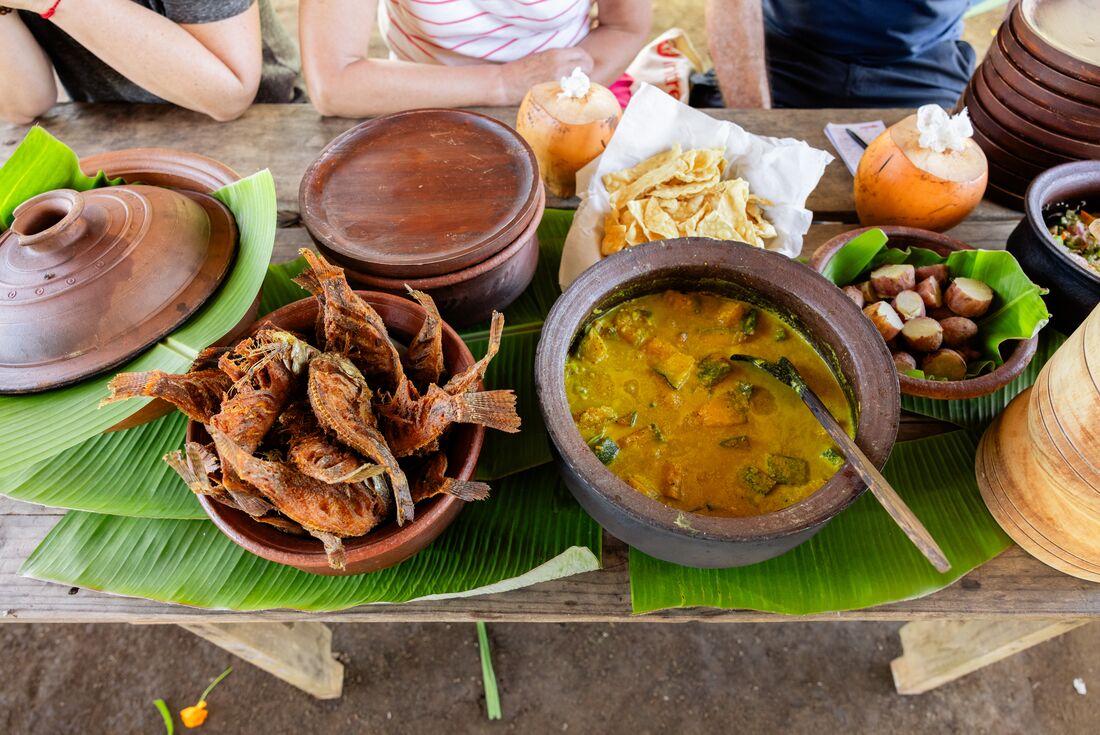 Assortment of food in bowls on banana leaves at the Chena Cultivation Tour
