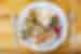 Plate of fresh healthy food with meat on a neat plate with wooden table