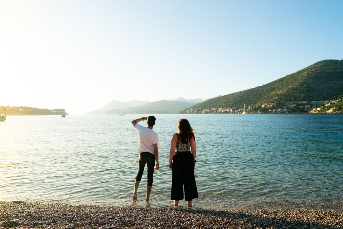Two 18 to 35s travellers look out before sunset on a Dubrovnik beach