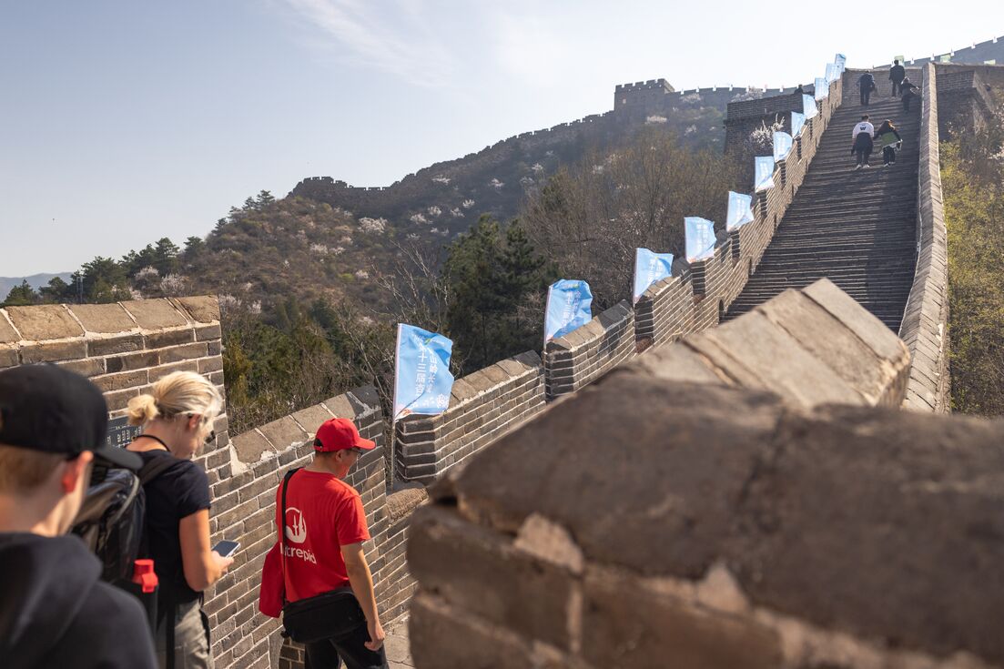 Leader takes travellers on a walk on the Great Wall Of China, Beijing, China 