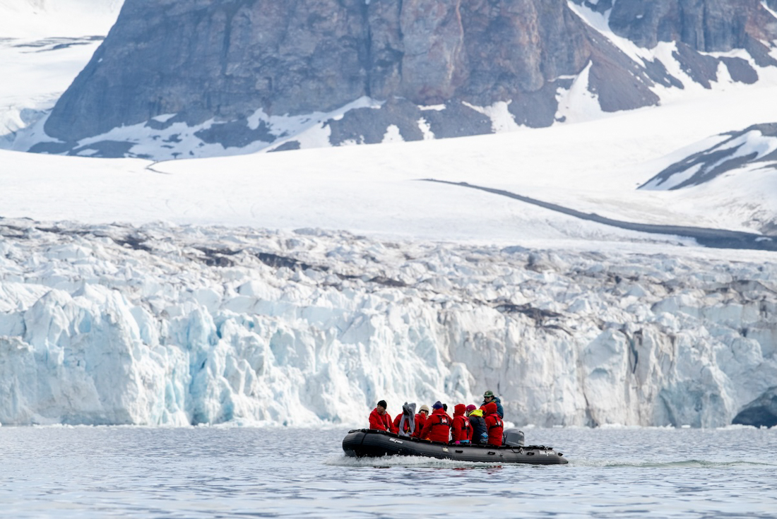 Zodiac cruising among the mountains and glaciers of Fjortende Julibukta