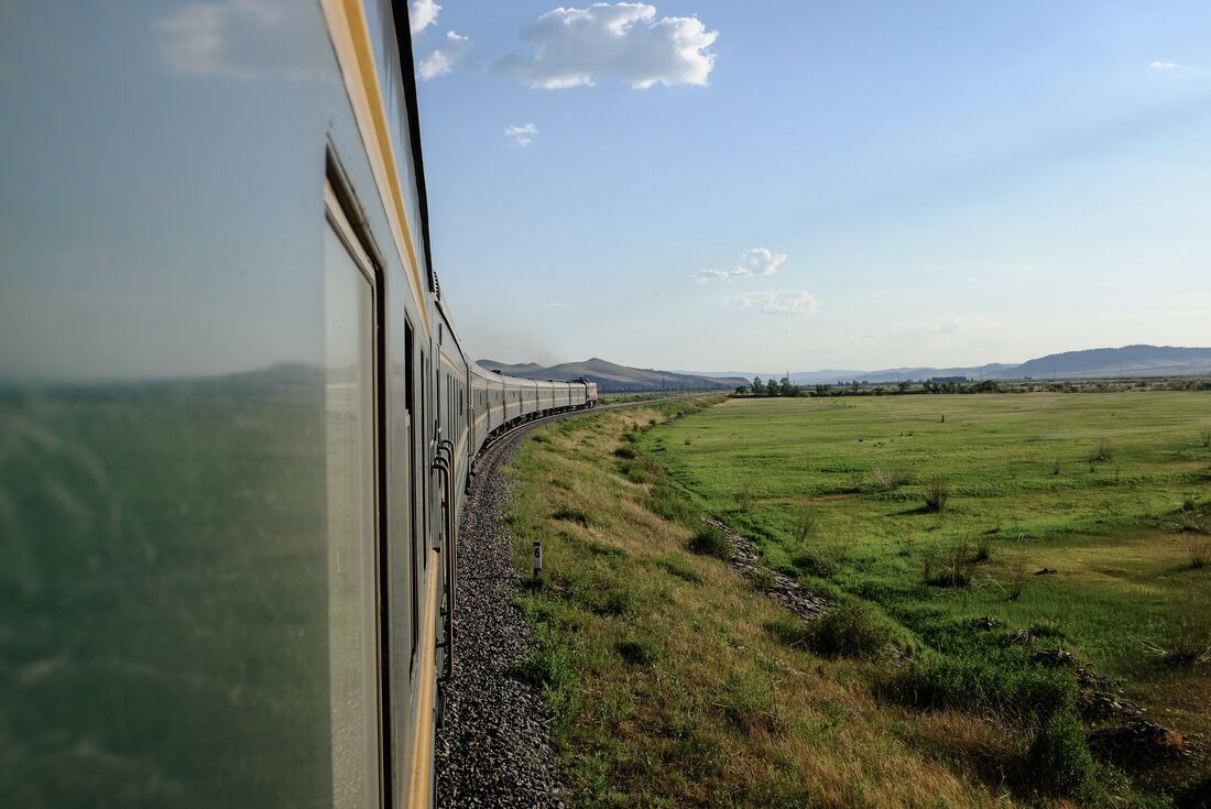 Green Trans-Mongolian train curves into the grasslands of Mongolia and China