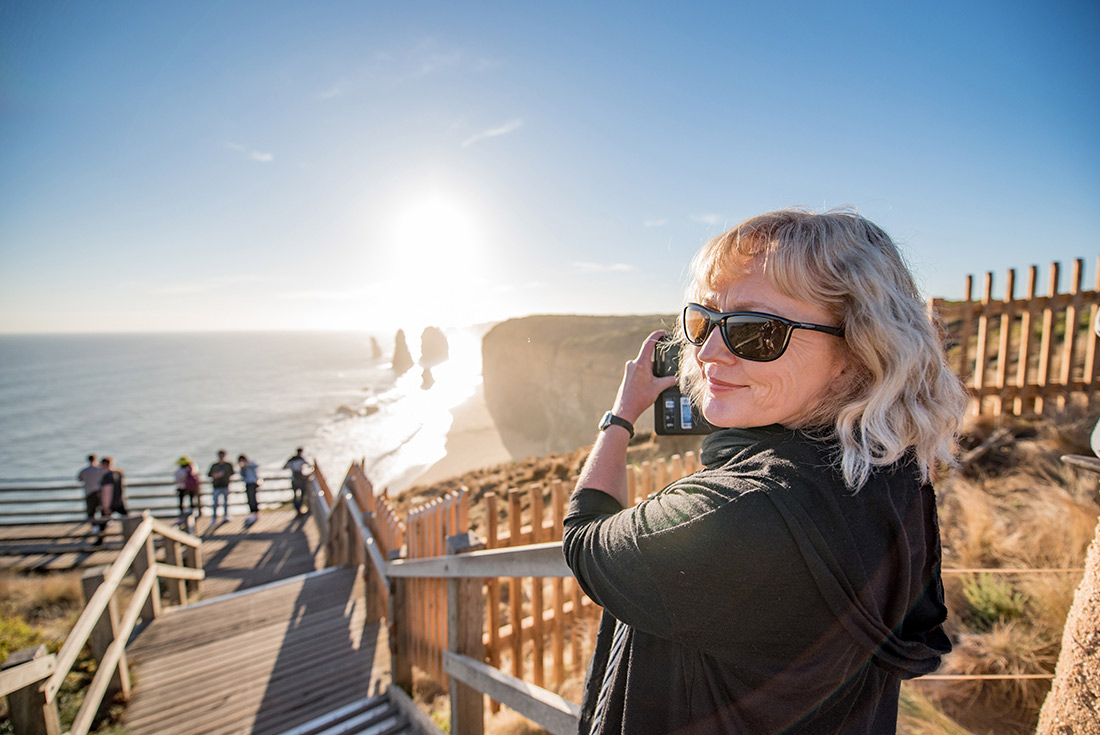 Traveller taking photo of Twelve Apostles, Great Ocean Road, Victoria, Australia