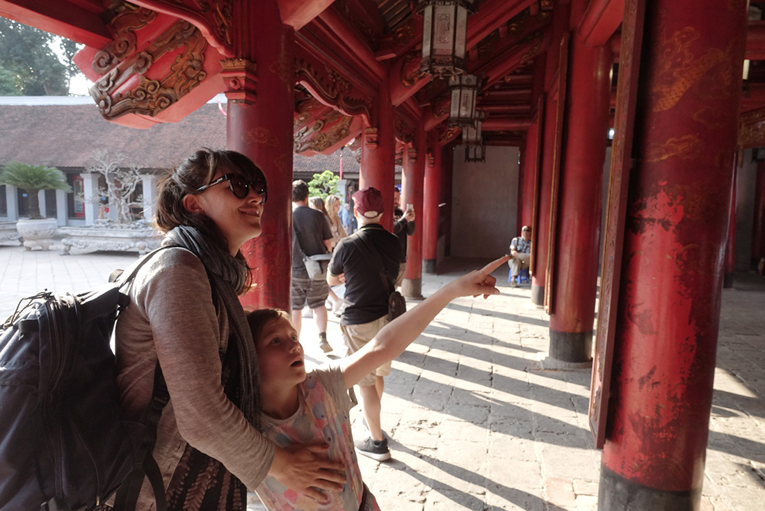 Mother and daughter looking at period Vietnamese architecture at a temple in Hue, Vietnam on an Intrepid Travel tour.