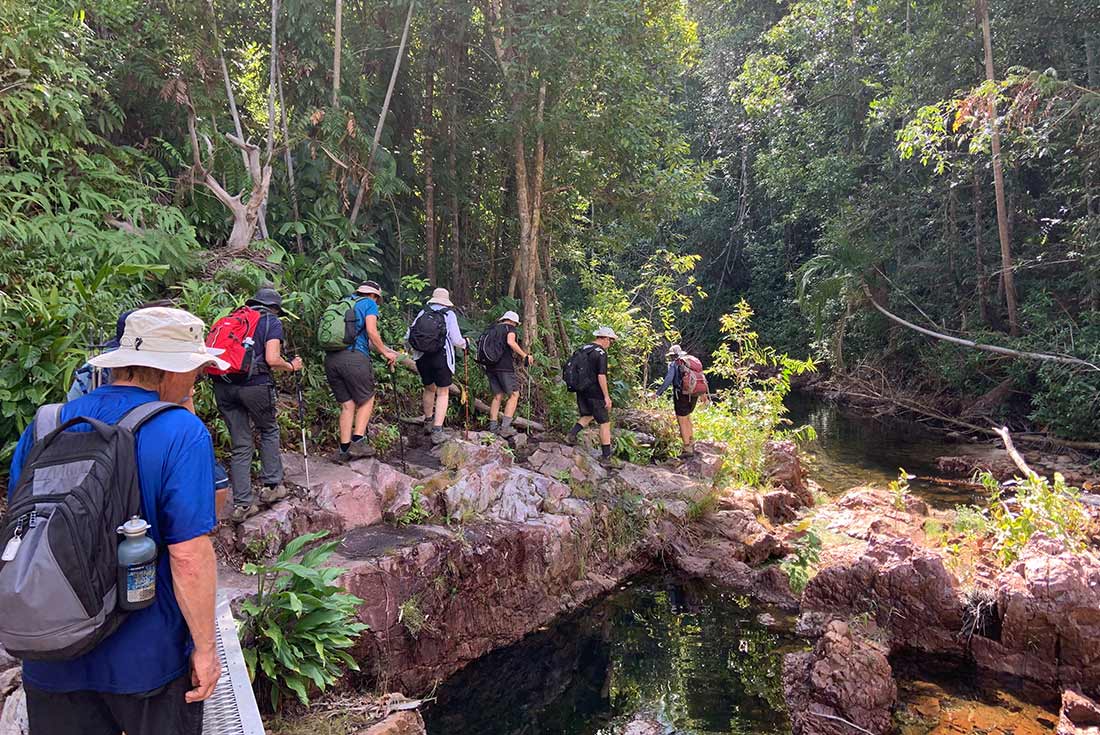 Group hiking through Cascade Falls, Northern Territory, Australia