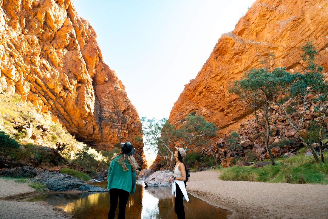 Travellers looking up at Simpsons Gab, Northern Territory, Australia