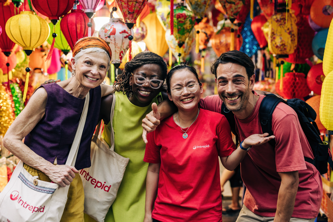 Group of Intrepid travellers and leader on walking tour of Hanoi