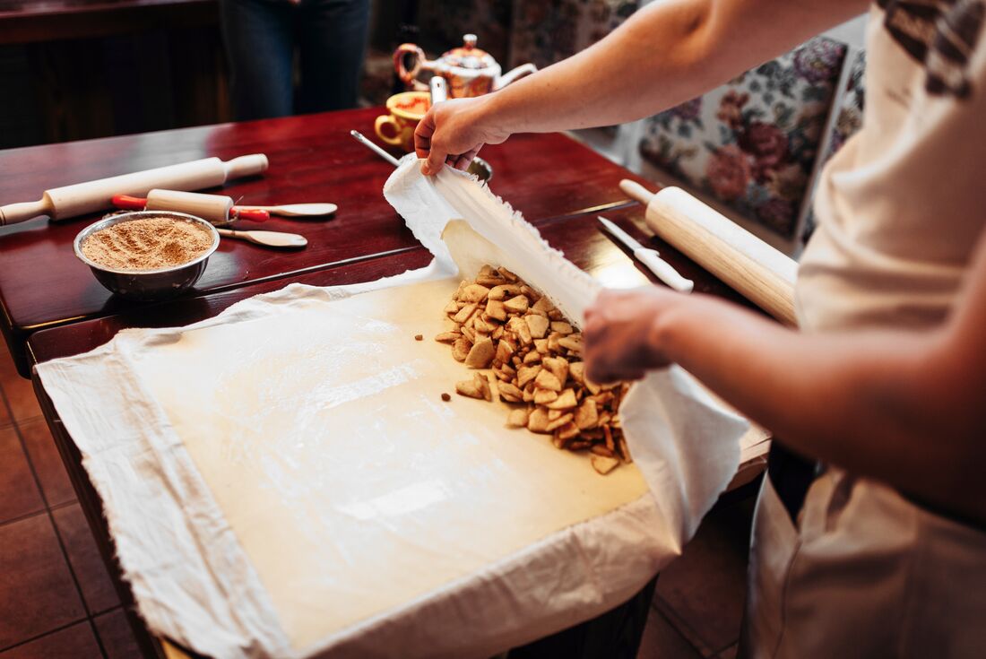 Local guide preparing Austrian strudel in Vienna kitchens