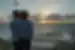 Travellers looking out at Coral Bay at sunset