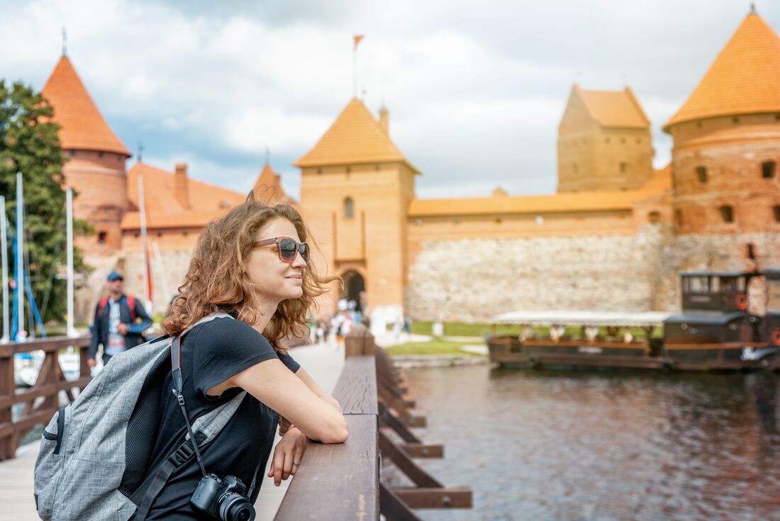 Traveller on the bridge to Trakai castle in Lithuania